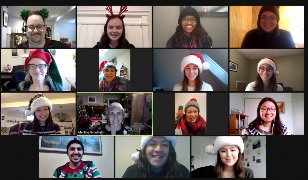 Screenshot of 5 of our staff members connecting via video chat. All are wearing Santa, elf, or winter hats.